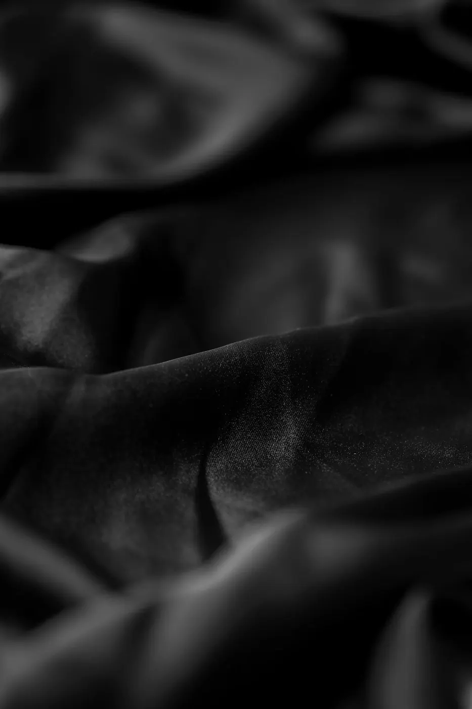 Close-up of soft black fabric with folds and shadows